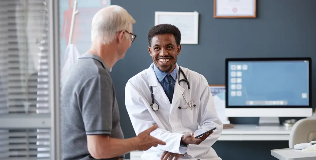 Doctor holding clipboard speaks to patient; text on screen reads "Don't ignore signs of a blood clot."